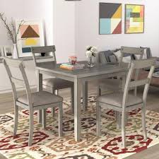 A small dining space with a wooden dining table paired with black chairs over concrete flooring. Gray Dining Room Sets Kitchen Dining Room Furniture The Home Depot