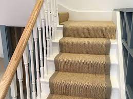 grey carpet to stairs with black