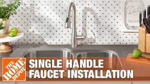 a kitchen faucet with a single handle