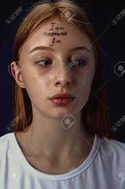 While religious beliefs may help a person come to terms with physical illness. Portrait Of Young Woman With Mental Health Problems The Image Of A Tattoo On The Forehead With The Words Im Restless Fine Concept Of Hidding The True Feelings Psycological Trouble Treatment Stock Photo