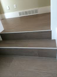 I would love to hear your expert opinions about this. Wood Floor Tile On Stairs With Metal End Cap Tile Stairs Laminate Stairs Laminate Flooring On Stairs