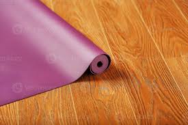a lilac colored yoga mat is spread out