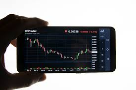 Man Checking Ripple Price Graph Chart On Mobile Phone Scre