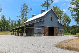 This horse barn resembles a garage with its doors and siding. Beautiful Barns Made For Cowgirls Cowgirl Magazine