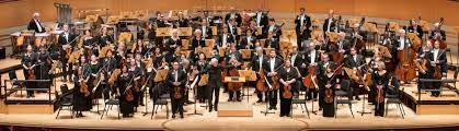A large classical orchestra, including string, wind, brass, and percussion instruments. The Pacific Symphony Blog A Classical Music Website Dedicated To Pacific Symphony