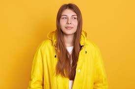 Free Photo | Young attractive student girl wearing jacket, having beautiful  straight hair, standing against yellow wall, looks thoughtful.