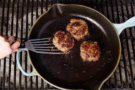 burgers in a cast iron skillet
