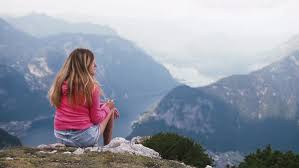 Woman sitting on mountain top and contemplating beautiful view - Stock  Video Footage - Dissolve