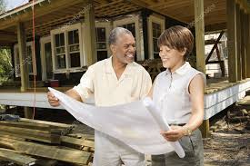 Couple Holding Building Plans Stock