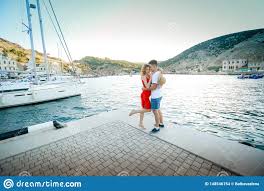 young couple hugs and relaxing at dock