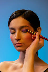 a person applying eyeshadow makeup to a