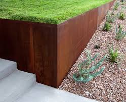 Here, raw timber and bronzed corten steel were selected for their rustic country feel. Cat Mountain Austin Outdoor Design Modern Landscaping Steel Retaining Wall Steel Planters