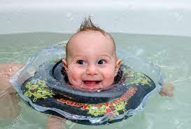 Toddler baby bath hat shower shampoo visor hats wash hair ear shield cap soft. Child With Rubber Ring Floating In A Bath Of Clear Water And Smiling Stock Photo Picture And Royalty Free Image Image 71014031