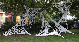 They show you how to make funny little spiders from rocks and sticks that have been painted, glued together, and topped off with funny googly eyes. How To Make Giant Halloween Spider Webs South Lumina Style Spider Web Halloween Decorations Diy Halloween Spider Web Halloween Spider Decorations