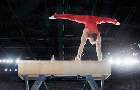 male gymnast performing upside down