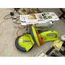 a garden groom hedge trimmer and a