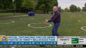 The green grass now has circles, marking ways to physically distance while at the popular city park. Park Crews Painting Social Distancing Circles At Trinity Bellwoods Park