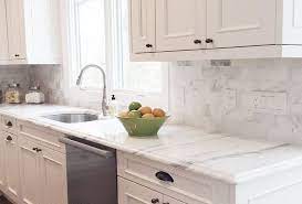 The carrara marble backsplash extends from the countertops to the ceiling in this kitchen design. Kitchen Backsplash Tile Hand Made Tiles Ceramic Tiles