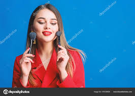 attractive woman applying makeup brush