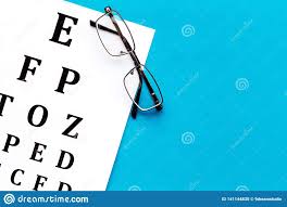 Eye Examination Eyesight Test Chart And Glasses On Blue