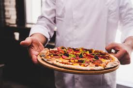Chef Holding The Delicious Pizza