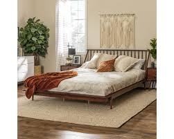The headboard is larger than the footboard giving it a cosy feel — both pieces curve upwards and outwards like a sleigh. Walker Edison Walnut King Mid Century Modern Solid Wood Spindle Platform Bed Bkspinwt Goedekers Com