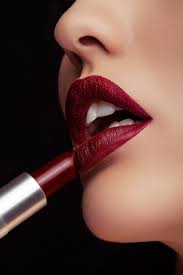 free photo applying red lipstick on