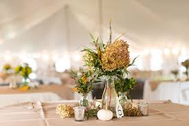 Blue jars with wildflowers and candle holders for a centerpiece. 24 Dried Flower Arrangements That Are Perfect For A Fall Wedding Martha Stewart