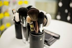 makeup brushes in a black leather