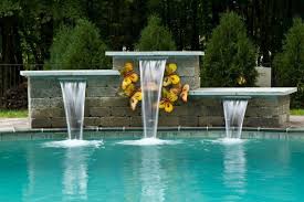 Create the right water feature for your swimming pool and it can be that intangible wow factor that lifts the value of your property. Pool Water Features Modern Pools With Waterfalls Swimming Pool Design Ideas Pool Waterfall Pool Water Features Swimming Pool Waterfall