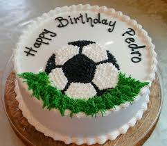 Baking off a round cake and cutting a bit from the middle will give you a perfect oval to decorate as a football! Soccer Decoration Birthday Cake Soccer Birthday Cakes New Birthday Cake Football Birthday Cake