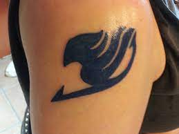 The Fairy Tail Guild's tattoo emblem is a colorful design on the back of their neck