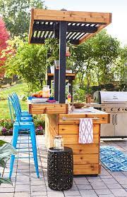 Invest in a kitchen island with seating and your guests will have a comfortable place to sit as they help chop up veggies for their supper. Outdoor Kitchen With Concrete Countertop