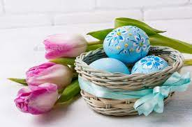 Happy Easter greeting with blue floral drcorated eggs in the wic Stock  Photo by TasiPas