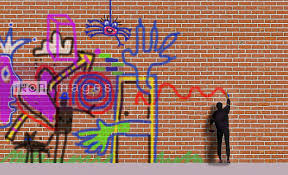 Man Spraying Graffiti On Brick Wall
