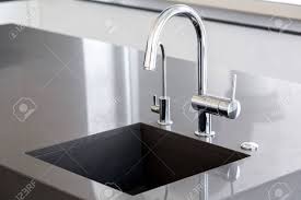 It has a commercial style design with lots of awesome features to become a fan of it. Kitchen Sink Of Dark Gray Stone With Chrome Faucet In A Clean Stock Photo Picture And Royalty Free Image Image 126331117