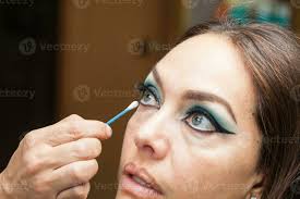 makeup artist cleaning and giving the