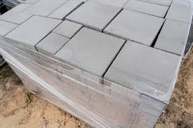 laying of gray concrete paving slabs