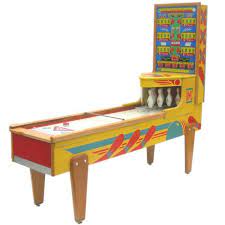 In cricket a bowling machine is a device which enables a batsman to practise (usually in the nets) and to hone specific skills through repetition of the ball being bowled at a certain length, line and speed. Arcade Shuffle Bowling Game 1stdibs Com Retro Arcade Bowling Games Arcade Game Machines
