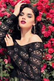 black lace dress posing beside roses