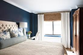 Ivory Tufted Bed On Dark Blue Wall