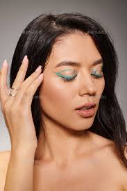 brunette asian woman with green eye