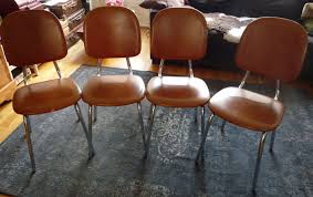 four brown plaster kitchen chairs