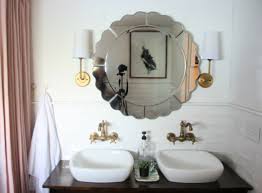 a bathroom mirror over tile wainscoting