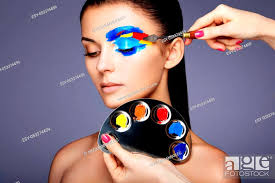 makeup artist applies colorful makeup