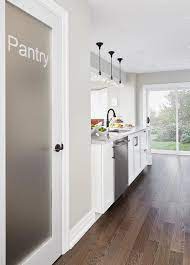 A Frosted Glass Pantry Door Is Located