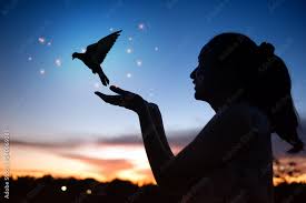 woman praying and free bird enjoying
