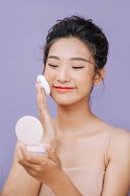 beautiful asian woman using powder puff