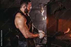 male blacksmith forging in his work
