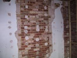 drywall over a rendered plaster wall